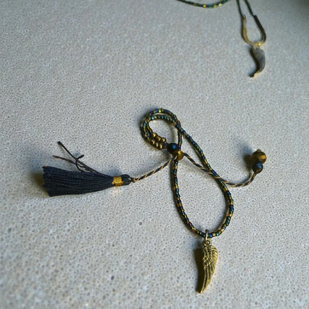 Gold Wing Charm Bracelets. One‎ With Black Accents And One With Blue.
